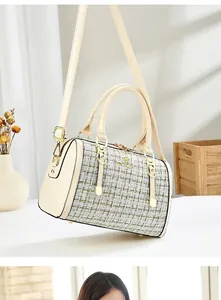 Beige tweed Boston handbag with golden threads, leather handles, and dual zippers