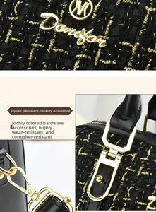 Macro detail of golden hardware and black tweed fabric on a stylish luxury handbag