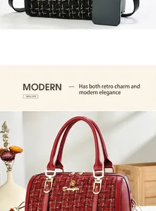 Detail of red and black plaid tweed Boston bag featuring gold hardware and twin handles