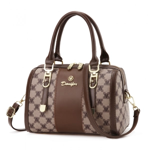 Classic Boston handbag with brown leather trim and monogram canvas on white background