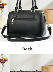 Detail view of the black Boston bag back showing the secure zipper pocket and gold hardware