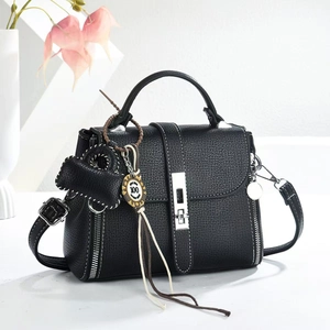 Black pebble leather handbag with white stitching, silver lock and heart charm