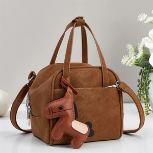 Brown vintage faux leather handbag with a cute pony charm and adjustable strap