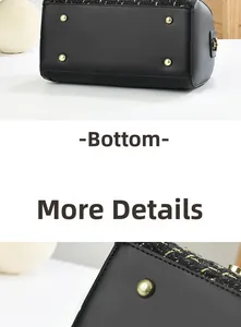 Detail of black tweed crossbody bag bottom with gold metal protective feet and stitching