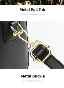 Close-up of gold-tone metal zipper and hardware details on black leather bag
