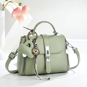 Chic light green pebbled leather handbag with adjustable strap and silver metal lock