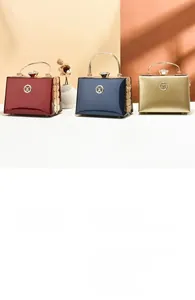 Detailed view of elegant evening clutches in wine red, navy, and champagne gold