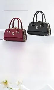 Glossy patent leather evening bag with golden hardware and chic circular logo detail