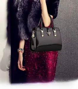 Macro shot of black crocodile embossed leather handbag with elegant gold hardware