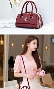 Detail of burgundy patent leather evening bag with diamond clasp and circular metal logo