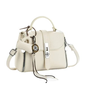 Chic beige textured leather handbag with silver lock and heart charm pendant