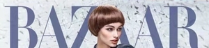 Short dark brown bob wig with bangs shown in a professional fashion magazine shoot