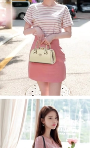 Detailed macro view of champagne gold glossy leather handbag with round metal logo ornament