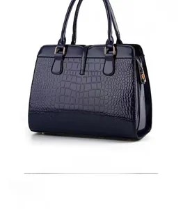 Rear view of navy blue faux crocodile leather handbag with elegant golden hardware detail