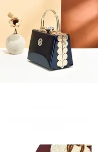 Detail of glossy blue patent leather evening bag with elegant golden round handle