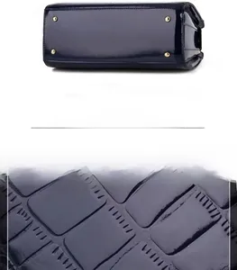 Detail of dark blue crocodile pattern patent leather handbag bottom with gold studs