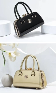 Detail of glossy patent leather handbags with crystal clasps and gold-tone metal hardware