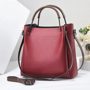 Close-up of burgundy litchi grain tote bag with dark brown handles and detachable strap