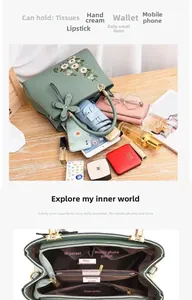 Detailed interior of light green floral handbag showing multiple storage compartments