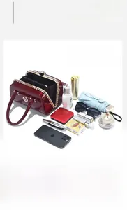 Deep red patent leather bag with rhinestone clasp showing spacious interior for essentials