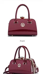 Close-up of wine red patent leather handbag with diamond clasp and gold chain detail