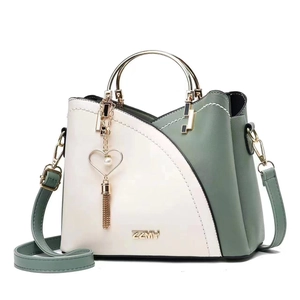 Elegant white and green contrast leather handbag with round handle and pearl heart charm