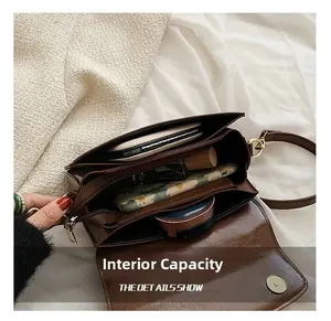 Internal capacity of vintage brown leather bag showing multi-layer storage and compartments