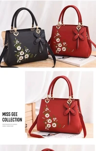 Detail of floral embroidery and heart metal hardware on a classic Chinese style handbag