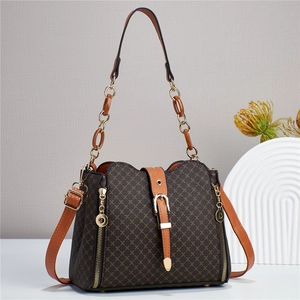 Detail of vintage brown plaid bucket bag with gold hardware and dual shoulder straps
