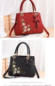 Detail of floral embroidery and heart-shaped metal handle on Chinese style handbags