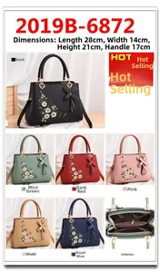Detailed view of floral embroidery and interior compartments on women's shoulder bag