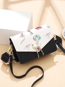 Fashionable black and white crossbody bag with vintage print and pearl cat buckle