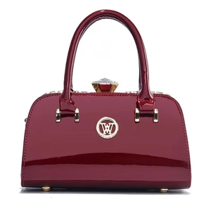 Glossy burgundy patent leather evening bag with diamond clasp and gold hardware accents