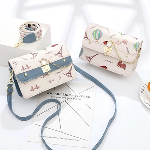 Fashionable travel themed crossbody bag with Eiffel Tower print and metal chain