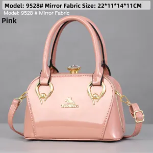 Pink patent leather handbag detail showing dimensions 22x11x14cm and rhinestones