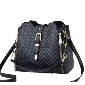 Minimalist grey bucket bag with cross pattern, gold hardware and leather strap
