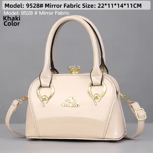 Detail view of khaki mirror leather handbag with dimensions 22x11x14cm and gold logo