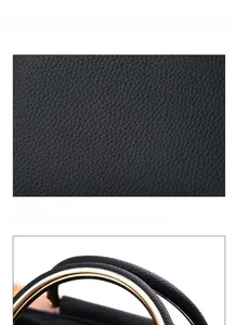 Détails macro du cuir PU noir grainé et de la poignée en anneau métallique doré