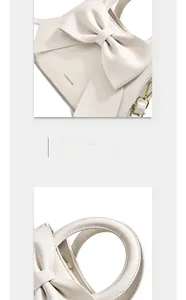 Gros plan sur un sac à main blanc avec un grand nœud et des détails métalliques dorés