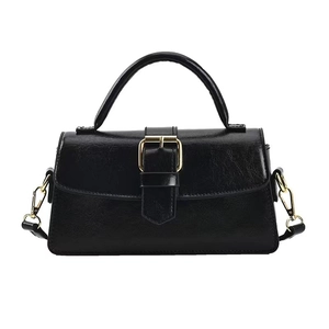 Classic black faux leather handbag with gold buckle and adjustable shoulder strap