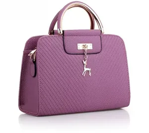 Detailed close-up of purple PU leather bag with V-shaped stitching and deer pendant