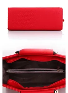 Detail of red faux leather handbag showing V-shaped quilted bottom and interior compartments
