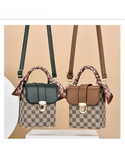 Detail of checkered mini bags in green and brown with silk scarf wrapped handles