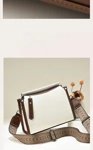 Detail of vintage patchwork crossbody bag with ethnic style wide strap and silver hardware