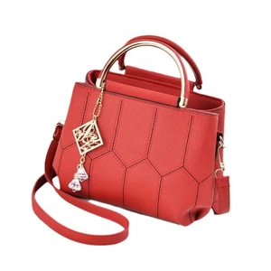Red pebbled leather handbag with hexagonal stitching and round gold metal handles