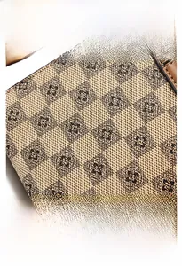Macro detail of checkered floral pattern PVC fabric with precision stitching on mini bag