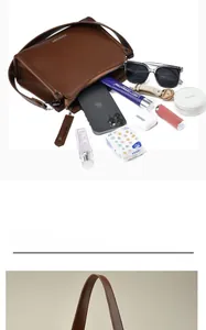 Internal storage detail of brown leather crossbody bag with daily essentials inside