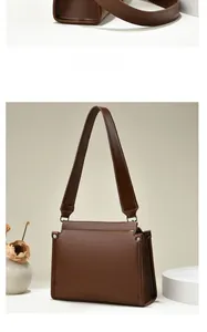 Detail view of brown leather shoulder bag featuring silver metal rivets on the side panel