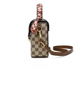 Side view of checkered crossbody bag featuring floral print and silk scarf handle