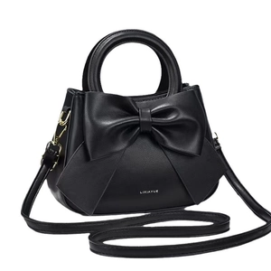 Sac à main chic en similicuir noir avec un grand nœud décoratif et une poignée